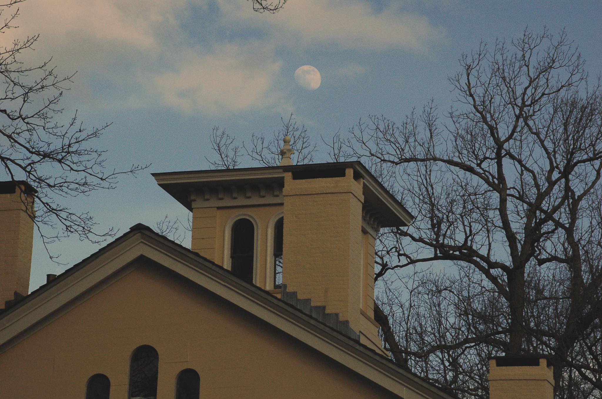 Photo of the top of Homestead in fall. It is still light out, but you can see the moon in the sky.