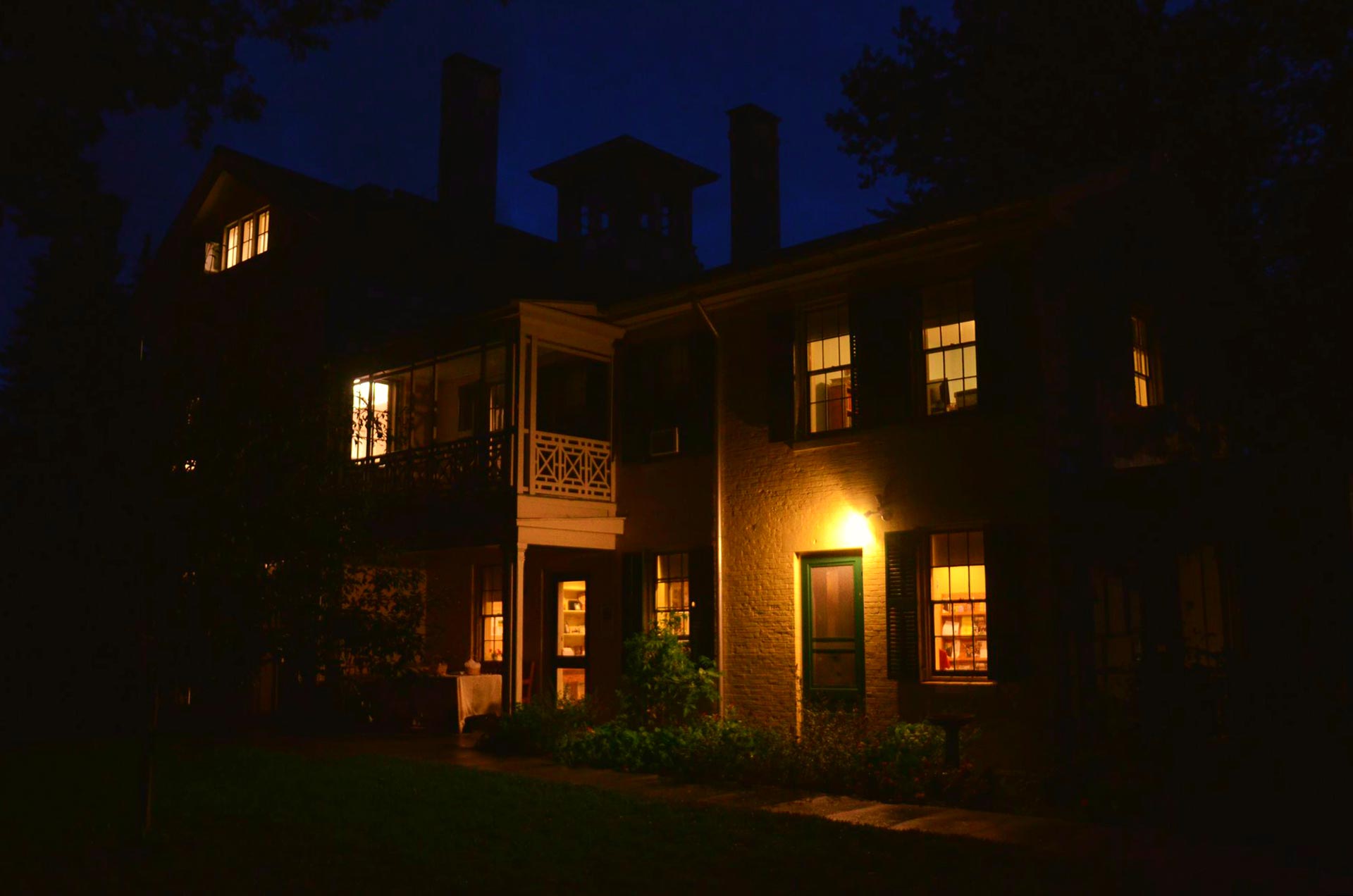 the homestead at night with lit windows