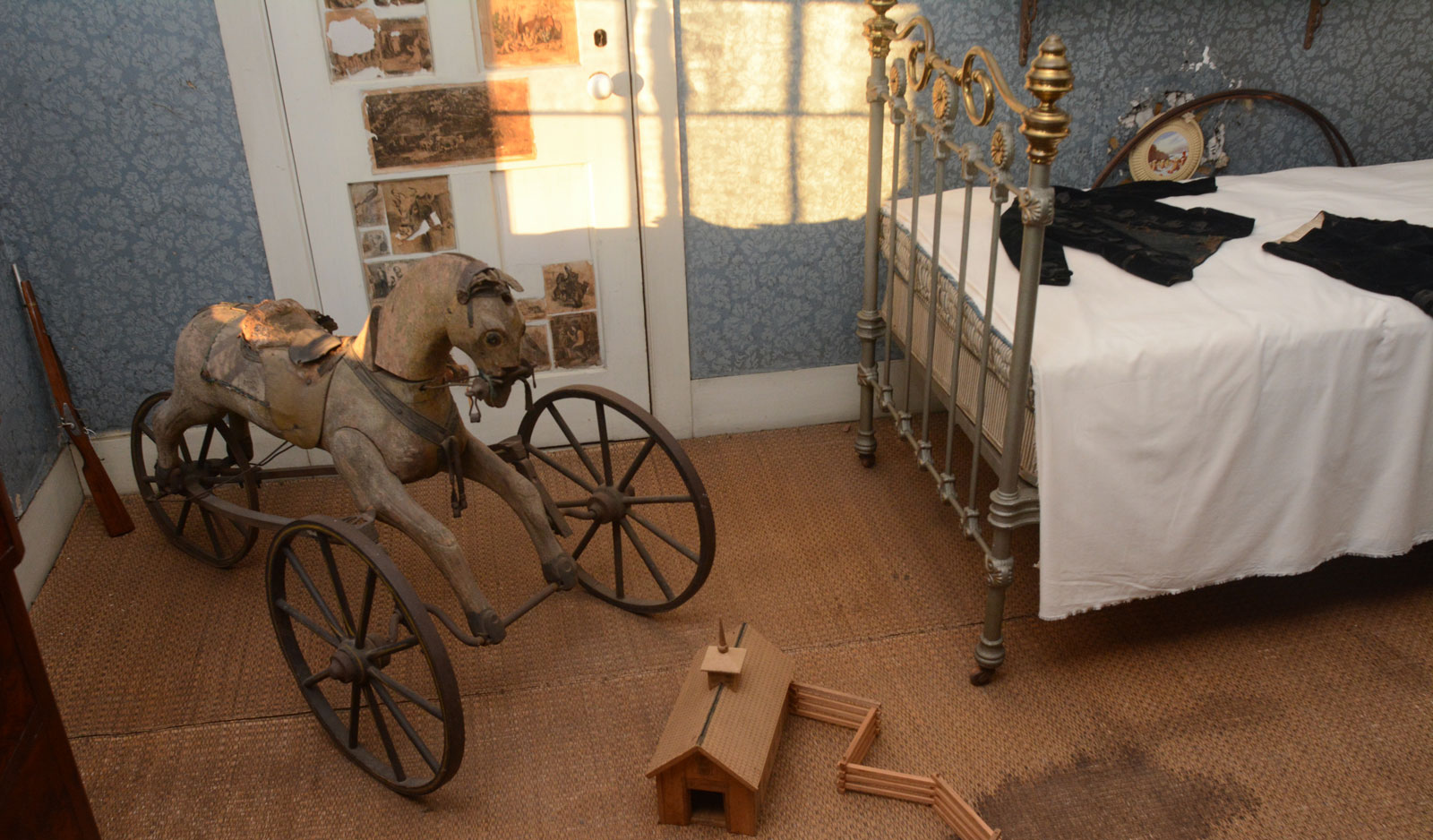 A wooden riding horse and other toys of the period